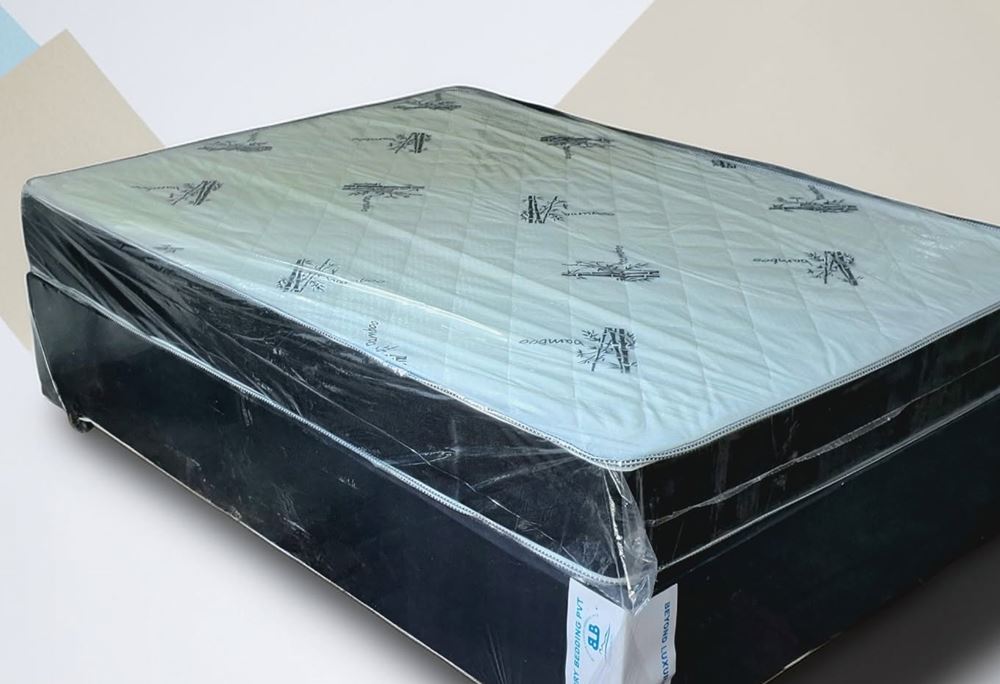 8-inch compressed foam double bed in protective wrap, with a bamboo-print top and a dark base