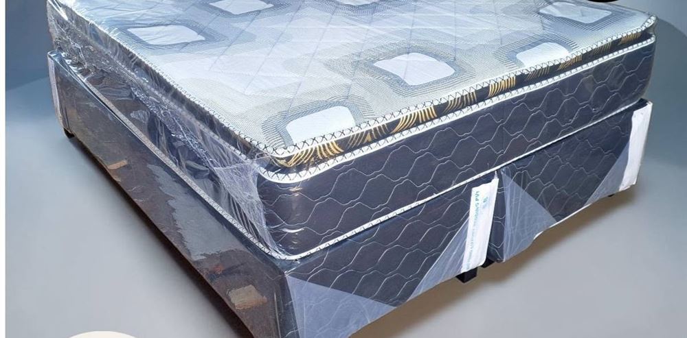 Queen pillowtop bed with a quilted top and a two-part dark base